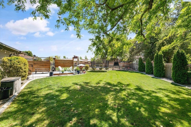 2519 W Grand Rhonde Pl, Kennewick, WA 99336 - view of yard featuring a trampoline, a patio area, and a playground