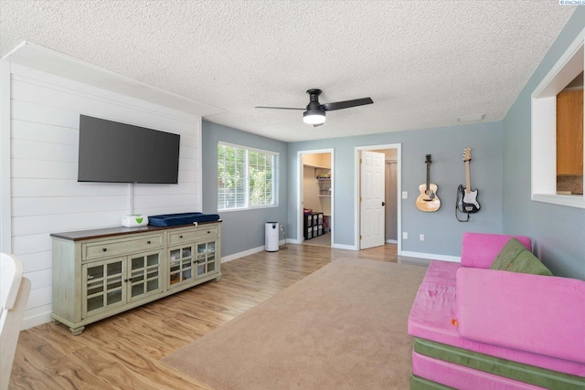 2519 W Grand Rhonde Pl, Kennewick, WA 99336 - living room with a ceiling fan, wood finished floors, a textured ceiling, and baseboards