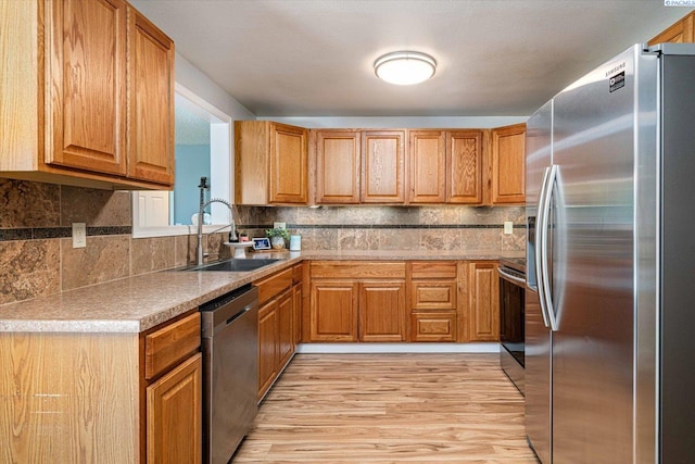 2519 W Grand Rhonde Pl, Kennewick, WA 99336 - kitchen with stainless steel appliances, a sink, brown cabinets, and backsplash