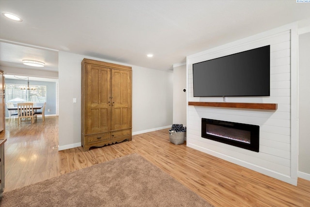 2519 W Grand Rhonde Pl, Kennewick, WA 99336 - unfurnished living room featuring wood finished floors, a large fireplace, a chandelier, baseboards, and recessed lighting