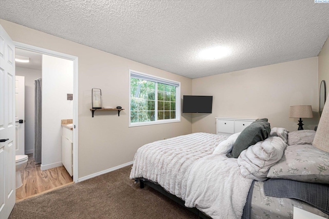 2519 W Grand Rhonde Pl, Kennewick, WA 99336 - bedroom with carpet floors, a textured ceiling, baseboards, and ensuite bathroom