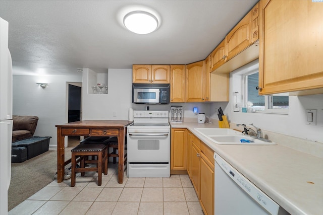 kitchen featuring light tile patterned flooring, sink, light brown cabinets, and white appliances