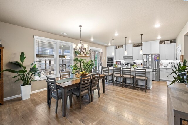 7867 Blanchard Loop, West Richland, WA 99353 - dining room featuring a chandelier, light wood-style floors, and recessed lighting