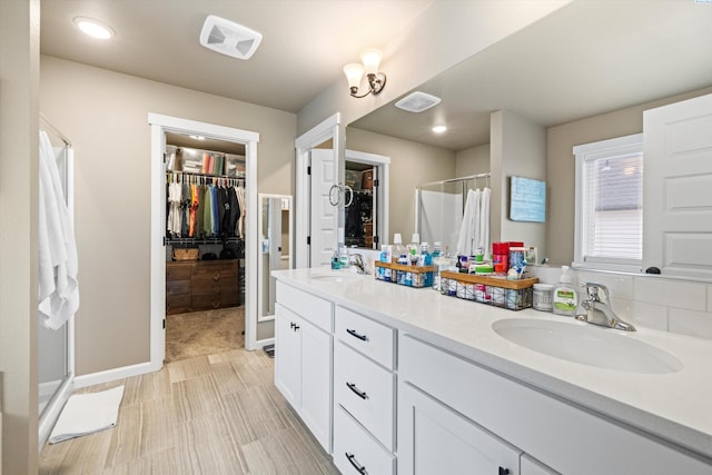 7867 Blanchard Loop, West Richland, WA 99353 - full bathroom featuring a stall shower, a spacious closet, double vanity, and recessed lighting