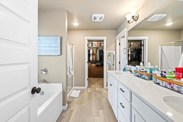 7867 Blanchard Loop, West Richland, WA 99353 - bathroom with a stall shower, a walk in closet, double vanity, and a garden tub