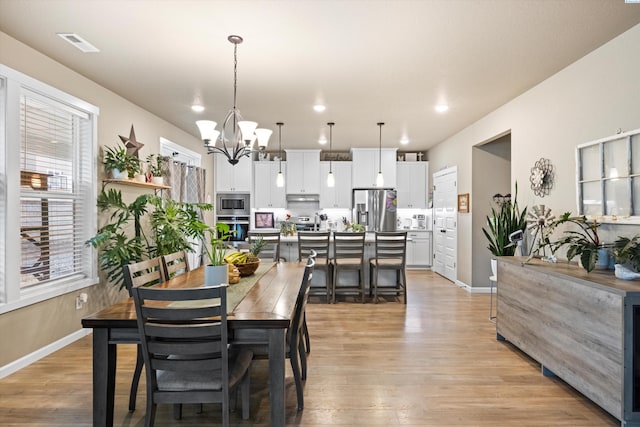 7867 Blanchard Loop, West Richland, WA 99353 - dining space featuring a chandelier, light wood-style floors, and recessed lighting