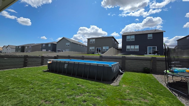 7867 Blanchard Loop, West Richland, WA 99353 - fenced backyard featuring a trampoline and a residential view