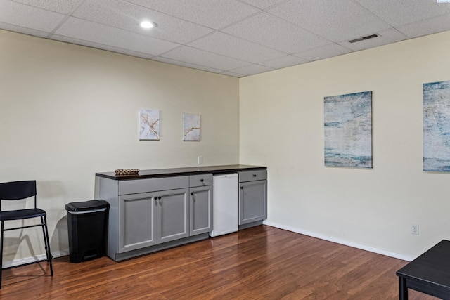 1348 Rohman Dr, Prosser, WA 99350 - bar featuring a drop ceiling, dark wood-style flooring, baseboards, and visible vents