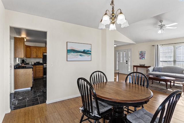 1348 Rohman Dr, Prosser, WA 99350 - dining area featuring baseboards, lofted ceiling, light wood-style flooring, and ceiling fan with notable chandelier