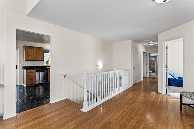 1348 Rohman Dr, Prosser, WA 99350 - hall with baseboards, visible vents, an upstairs landing, and hardwood / wood-style flooring