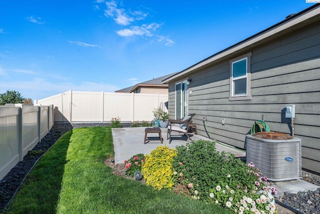 view of yard with a patio area and central air condition unit