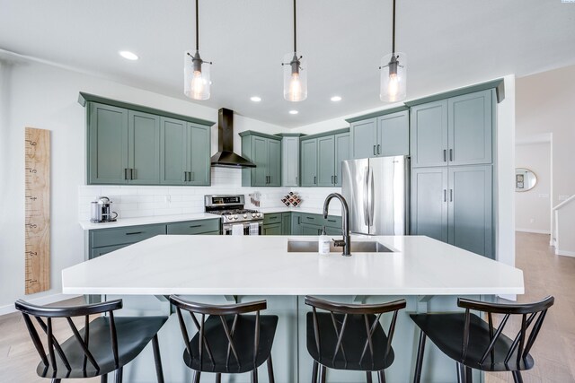 930 SW Finch Way, Pullman, WA 99163 - kitchen with wall chimney exhaust hood, stainless steel appliances, decorative backsplash, light countertops, and a kitchen bar