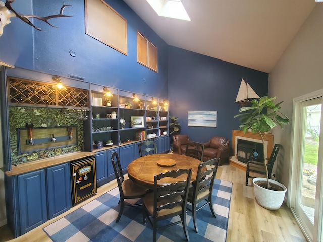 7218 W 15th Ave, Kennewick, WA 99336 - dining room with high vaulted ceiling, wet bar, wood finished floors, and a tiled fireplace