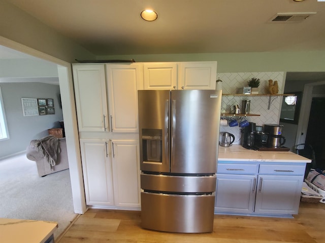 7218 W 15th Ave, Kennewick, WA 99336 - kitchen with stainless steel fridge, tasteful backsplash, white cabinets, light wood-style floors, and open shelves