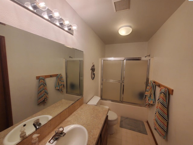 7218 W 15th Ave, Kennewick, WA 99336 - bathroom featuring toilet, combined bath / shower with glass door, and vanity