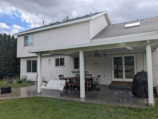 7218 W 15th Ave, Kennewick, WA 99336 - rear view of house with ceiling fan, a patio area, and a lawn
