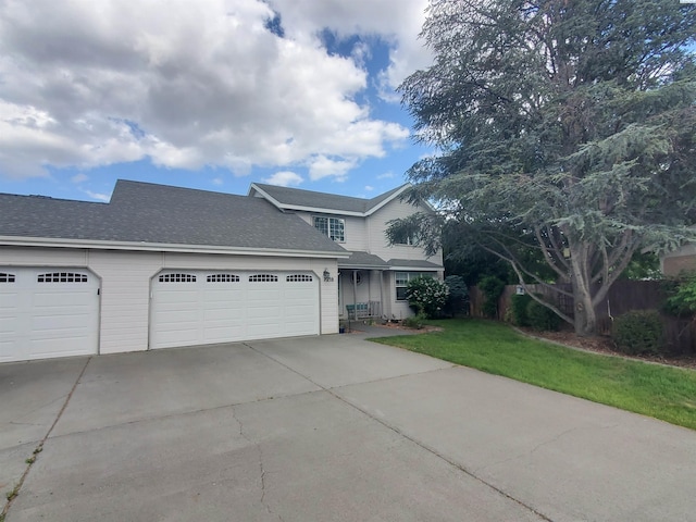 7218 W 15th Ave, Kennewick, WA 99336 - traditional-style house featuring driveway, a garage, a front lawn, and a shingled roof