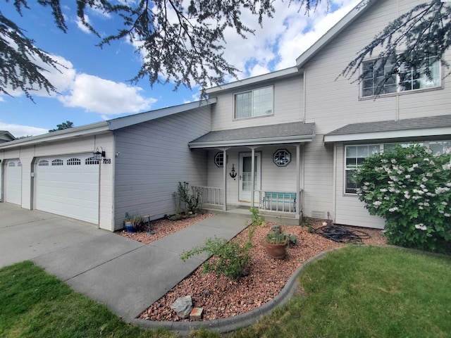 7218 W 15th Ave, Kennewick, WA 99336 - view of front of home with a porch, a garage, and concrete driveway