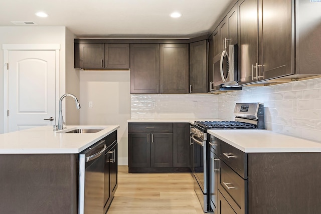 10402 Kokanee Dr, Pasco, WA 99301 - kitchen with appliances with stainless steel finishes, a sink, light wood-style flooring, and dark brown cabinets