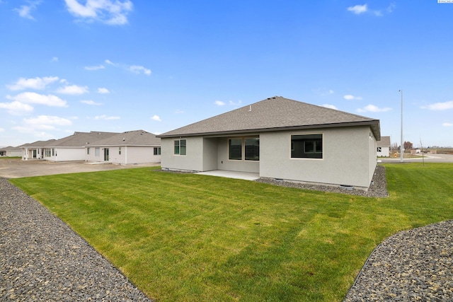 10402 Kokanee Dr, Pasco, WA 99301 - back of property with a yard, roof with shingles, stucco siding, and a patio
