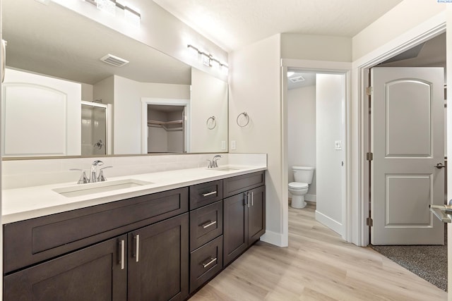 10402 Kokanee Dr, Pasco, WA 99301 - bathroom with toilet, a shower stall, visible vents, and a sink