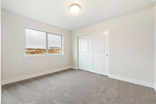 10402 Kokanee Dr, Pasco, WA 99301 - unfurnished bedroom featuring carpet floors, a closet, and baseboards