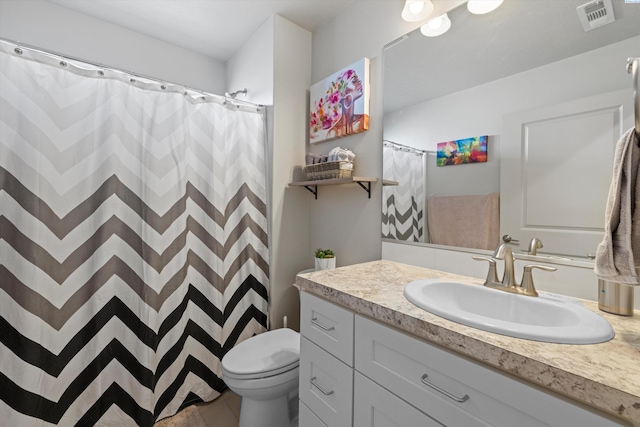 bathroom featuring toilet and vanity