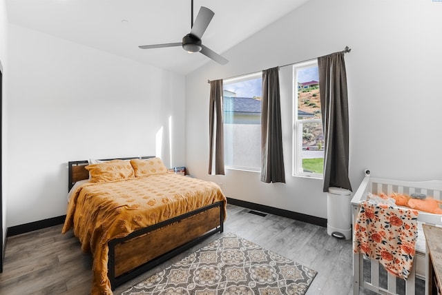 3312 Bing St, West Richland, WA 99353 - bedroom with multiple windows, vaulted ceiling, wood finished floors, a ceiling fan, and baseboards
