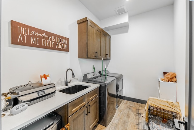 3312 Bing St, West Richland, WA 99353 - washroom with washer and clothes dryer, cabinet space, light wood-style floors, and attic access