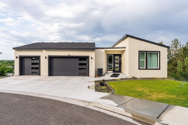 3312 Bing St, West Richland, WA 99353 - contemporary home featuring a garage, a front lawn, concrete driveway, and stucco siding