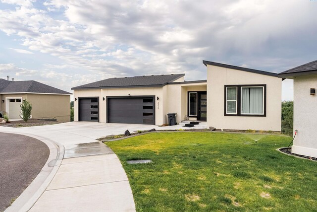3312 Bing St, West Richland, WA 99353 - view of front facade with a garage, driveway, stucco siding, and a front lawn