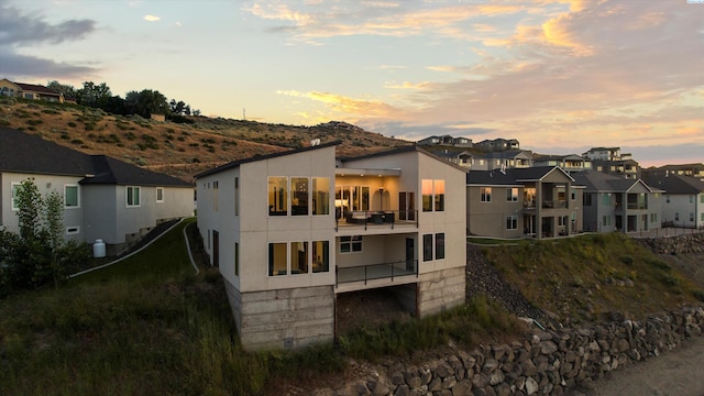 3312 Bing St, West Richland, WA 99353 - rear view of house with a balcony, a residential view, and stucco siding