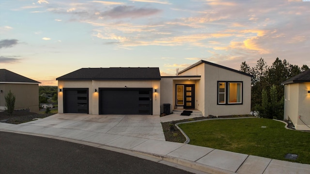 3312 Bing St, West Richland, WA 99353 - contemporary home with a garage, driveway, a yard, and stucco siding