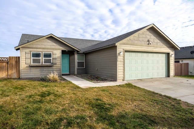 ranch-style home with a garage and a front lawn