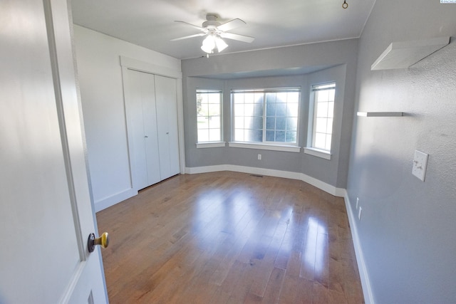 2780 Katie Rd, Kennewick, WA 99338 - unfurnished bedroom with baseboards, wood finished floors, a ceiling fan, and a closet