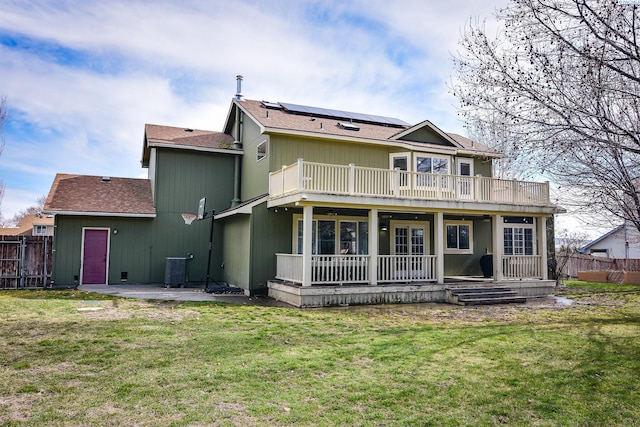 2780 Katie Rd, Kennewick, WA 99338 - rear view of property with solar panels, a patio area, a shingled roof, and a balcony