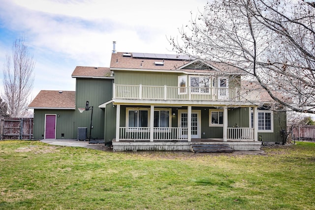 2780 Katie Rd, Kennewick, WA 99338 - back of house featuring roof mounted solar panels, a patio, roof with shingles, cooling unit, and a porch