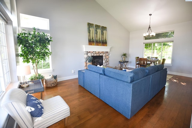 2780 Katie Rd, Kennewick, WA 99338 - living area with high vaulted ceiling, a chandelier, wood finished floors, baseboards, and a stone fireplace