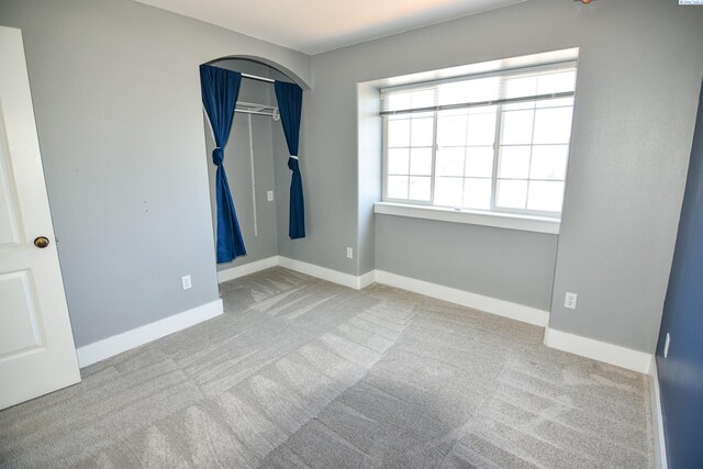 carpeted spare room with baseboards