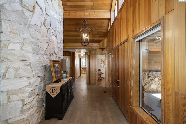 170732 Olsen Rd, Grandview, WA 98930 - corridor with dark wood-style flooring, wood walls, a chandelier, lofted ceiling, and wood ceiling