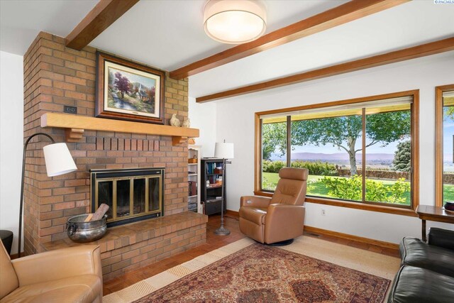 170732 Olsen Rd, Grandview, WA 98930 - living room with beam ceiling, a brick fireplace, and wood finished floors