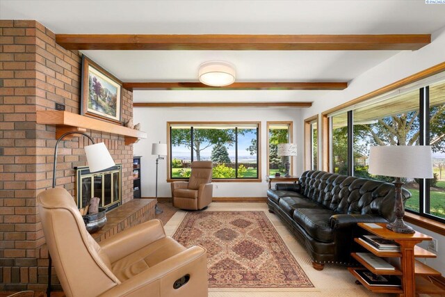 170732 Olsen Rd, Grandview, WA 98930 - living room with plenty of natural light, wood finished floors, beam ceiling, and a fireplace