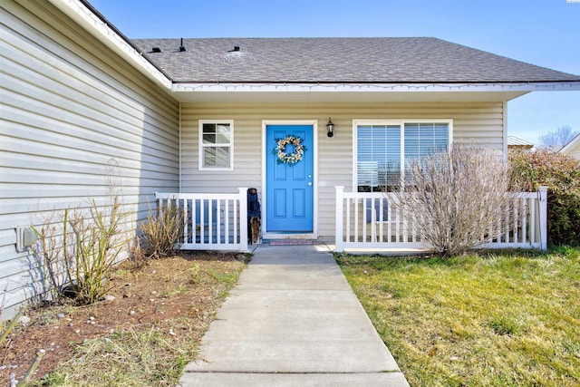 property entrance featuring a shingled roof and a porch