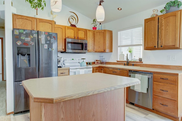 kitchen with lofted ceiling, light countertops, appliances with stainless steel finishes, a sink, and a kitchen island