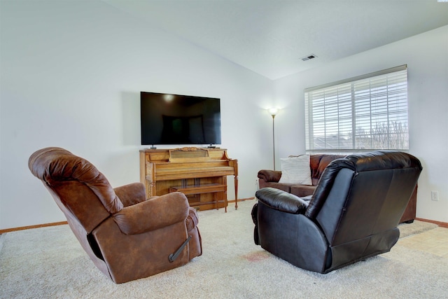 carpeted living area with lofted ceiling, visible vents, and baseboards