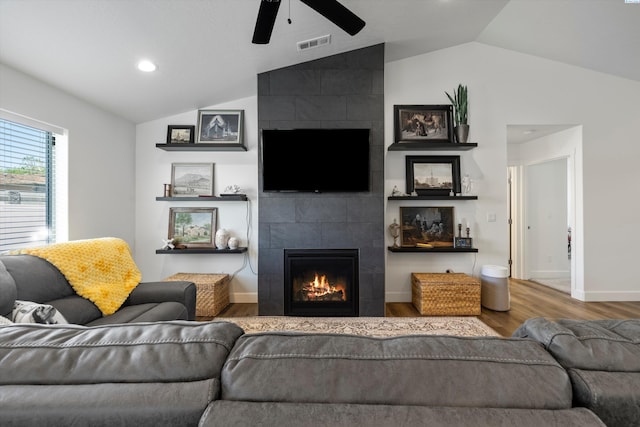 600 Lizzy Ln, Grandview, WA 98930 - living room with vaulted ceiling, a fireplace, visible vents, ceiling fan, and wood finished floors