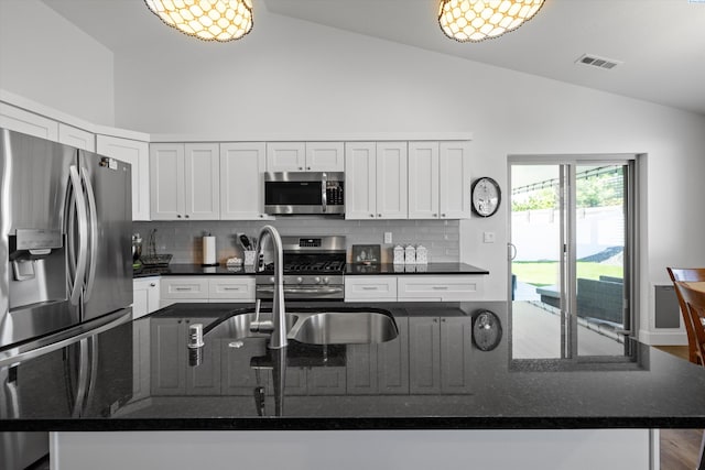 600 Lizzy Ln, Grandview, WA 98930 - kitchen with backsplash, white cabinets, visible vents, dark stone counters, and appliances with stainless steel finishes