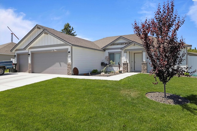 600 Lizzy Ln, Grandview, WA 98930 - craftsman house featuring board and batten siding, a front lawn, stone siding, and a garage