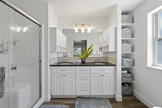 600 Lizzy Ln, Grandview, WA 98930 - bathroom featuring a shower stall, double vanity, a sink, and wood finished floors