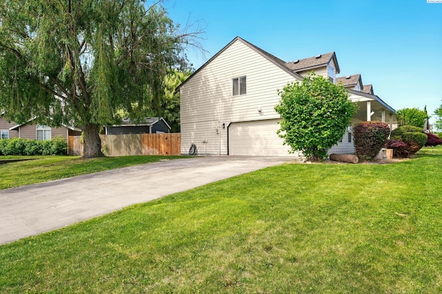view of side of property with an attached garage and concrete driveway